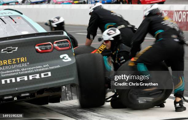 Pit crew members of the BREZTRI Chevrolet, change tires during the NASCAR Cup Series All-Star Race Qualifying Pit Crew Challenge at North Wilkesboro...