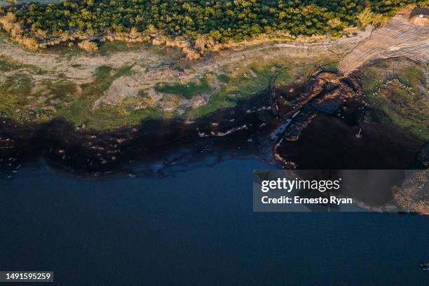 An aerial view shows the low level of water at Paso Severino Dam on May 17, 2023 in Florida, Uruguay. Paso Severino is considered the main fresh...