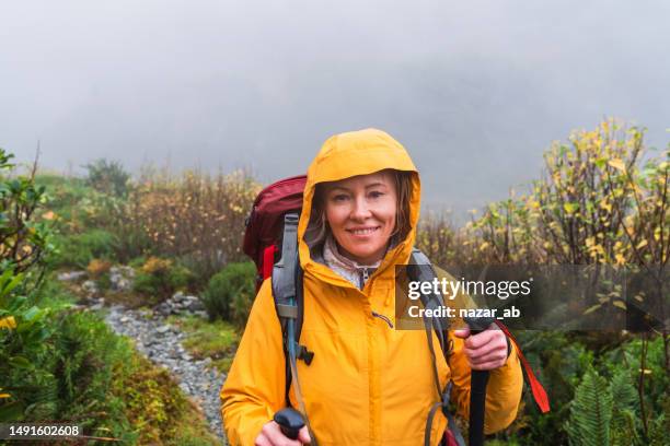 positive adventurous woman with hiking equipment exploring wilderness. - new zealand culture stock pictures, royalty-free photos & images