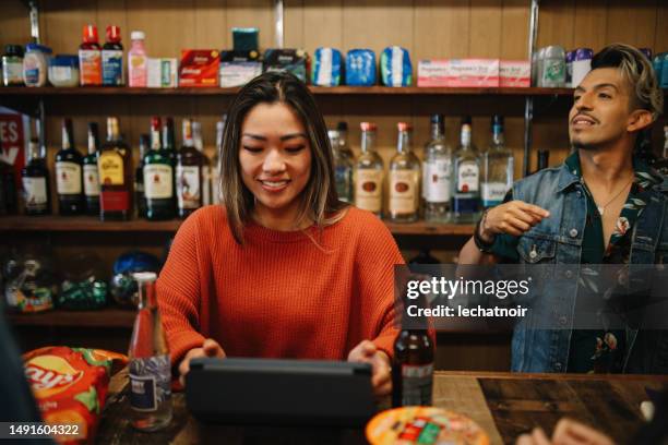 cashiers in a convenience store in los angeles, california - buying cigarettes stock pictures, royalty-free photos & images