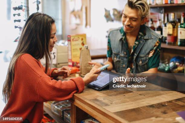 contactless payment at the convenience store - liquor store stock pictures, royalty-free photos & images