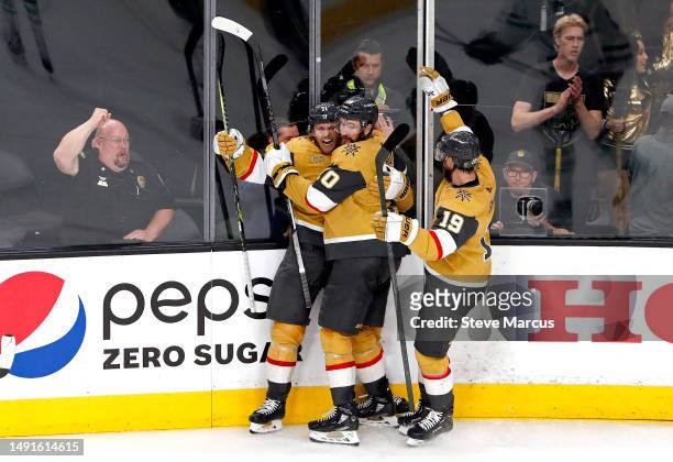 William Karlsson of the Vegas Golden Knights is congratulated by Nicolas Roy and Reilly Smith after scoring a goal against the Dallas Stars during...