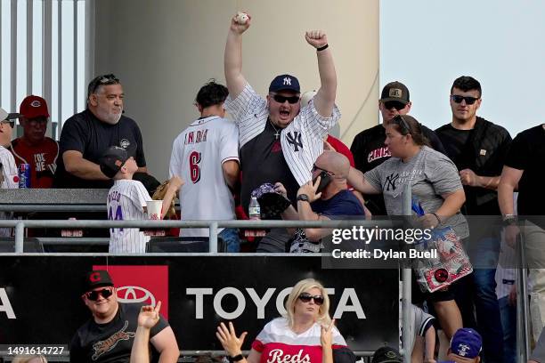 Fan celebrates after catching a home run hit by Aaron Judge of the New York Yankees in the first inning against the Cincinnati Reds at Great American...