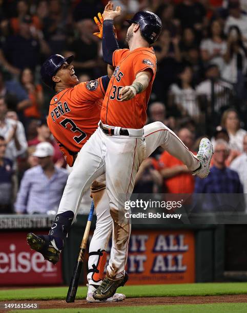 Kyle Tucker of the Houston Astros high fives Jeremy Pena after hitting a two run home run in the sixth inning against the Oakland Athletics at Minute...