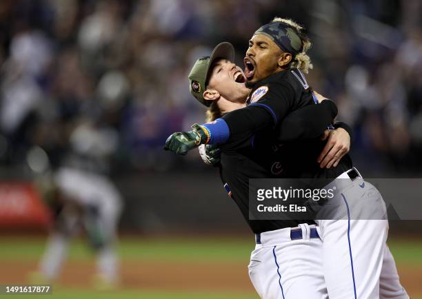 Francisco Lindor of the New York Mets is congratulated by Brett Baty after Lindor drove in the game winning run in the 10th inning against the...