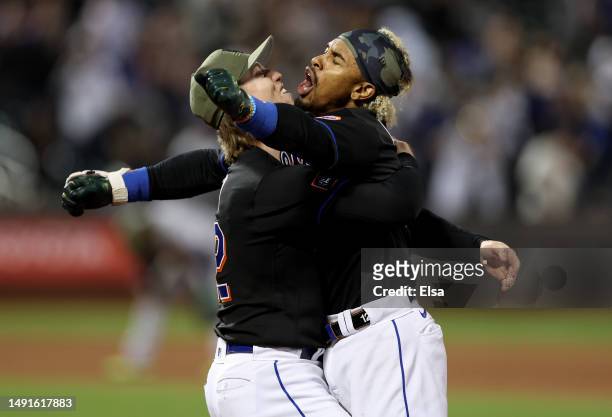 Francisco Lindor of the New York Mets is congratulated by Brett Baty after Lindor drove in the game winning run in the 10th inning against the...