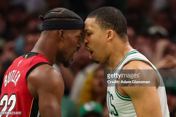 Jimmy Butler of the Miami Heat exchanges words with Grant Williams of the Boston Celtics during the fourth quarter in game two of the Eastern...