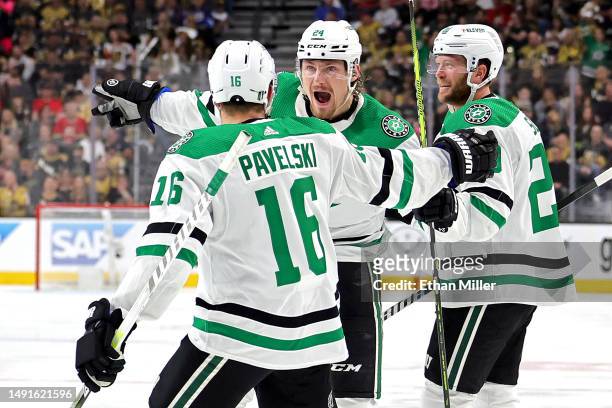 Roope Hintz of the Dallas Stars is congratulated by Joe Pavelski and Ryan Suter after scoring a goal against the Vegas Golden Knights during the...