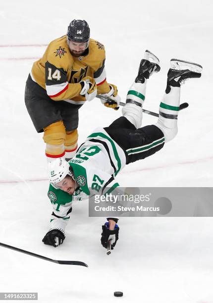 Mason Marchment of the Dallas Stars gets tripped up against Nicolas Hague of the Vegas Golden Knights during the third period in Game One of the...