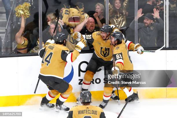Brett Howden of the Vegas Golden Knights is congratulated by Nicolas Hague and Mark Stone after scoring the game-winning goal against the Dallas...