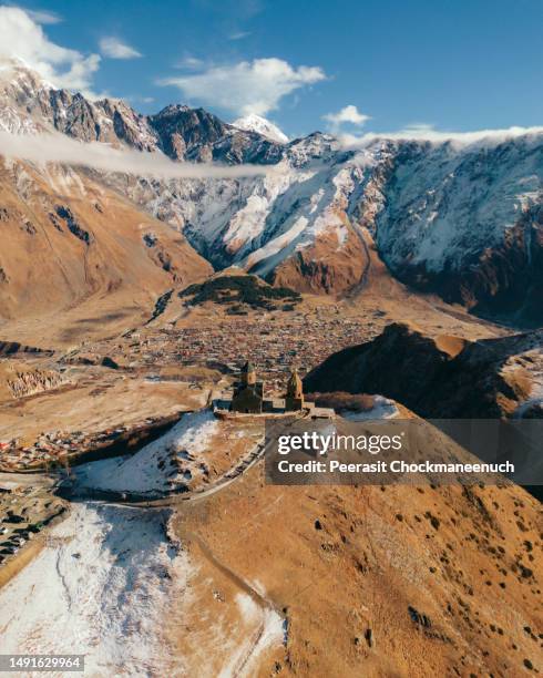 gergeti trinity church (kazbegi): iconic jewel of georgian landscapes - georgian stock pictures, royalty-free photos & images