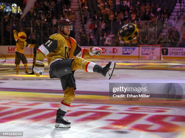 William Karlsson of the Vegas Golden Knights kicks a poker chip-themed pillow to fans after being named the second star of the game following the...