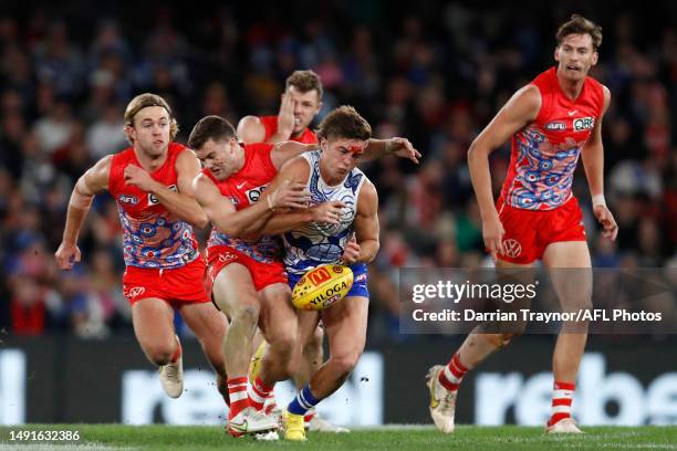 Tom Papley of the Swans tackles Will Phillips of the Kangaroos during the round 10 AFL match between North Melbourne Kangaroos and Sydney Swans at...