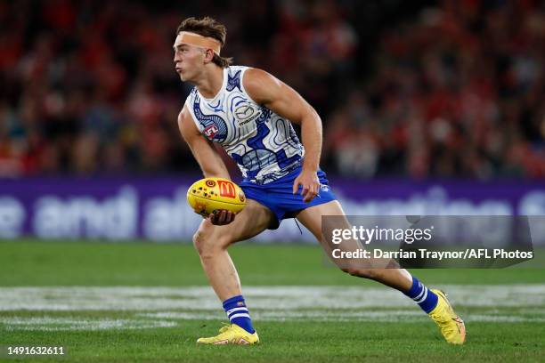 Will Phillips of the Kangaroos handballs during the round 10 AFL match between North Melbourne Kangaroos and Sydney Swans at Marvel Stadium, on May...