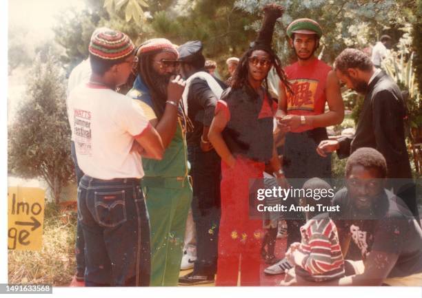 Rhythm guitarist and lead singer David Hinds middle with English roots reggae band Steel Pulse standing next to Fr. Amde Hamilton right priest of the...