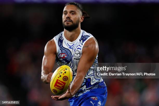 Aaron Hall of the Kangaroos handballs during the round 10 AFL match between North Melbourne Kangaroos and Sydney Swans at Marvel Stadium, on May 20...
