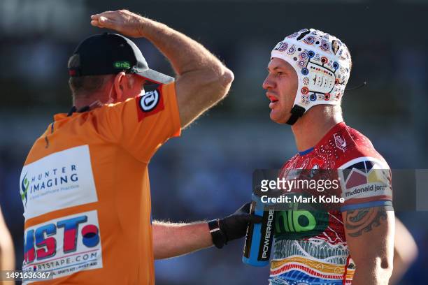 Kalyn Ponga of the Knights reacts as the trainer calls for a head injury assessment during the round 12 NRL match between Cronulla Sharks and...
