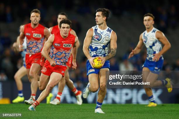 Jy Simpkin of the Kangaroos looks to pass the ball during the round 10 AFL match between North Melbourne Kangaroos and Sydney Swans at Marvel...