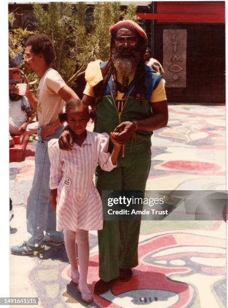 Lead drummer Steve Nisbett member of the English roots reggae band Steel Pulse right, and Fr. Amde Hamilton's granddaughter Quanesha Davis, and event...