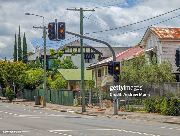 houses, traffic light on suburban street - yellow light stock pictures, royalty-free photos & images