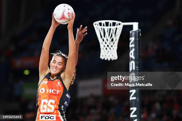 Matisse Letherbarrow of the Giants catches a pass ahead of Kadie-Ann Dehaney of the Lightning during the round 10 Super Netball match between Giants...