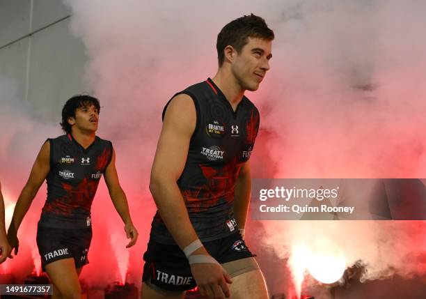 Zach Merrett of the Bombers leads his team out onto the field during the round 10 AFL match between Essendon Bombers and Richmond Tigers at Melbourne...
