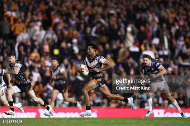 Jahream Bula of the Tigers makes a break during the round 12 NRL match between Wests Tigers and North Queensland Cowboys at Leichhardt Oval on May...