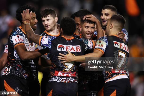 Starford To'a of the Tigers celebrates with team mates after scoring a try during the round 12 NRL match between Wests Tigers and North Queensland...