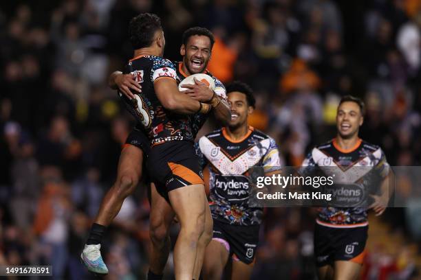 Starford To'a of the Tigers celebrates with Apisai Koroisau of the Tigers after scoring a try during the round 12 NRL match between Wests Tigers and...