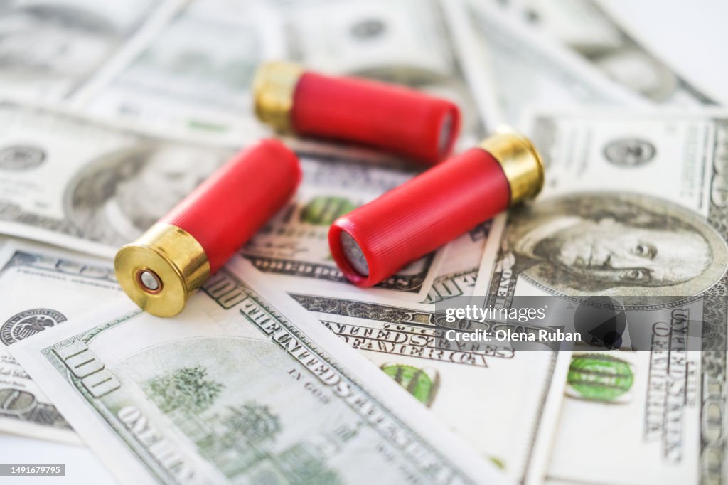 Shotgun shells on 100 US dollar bills.