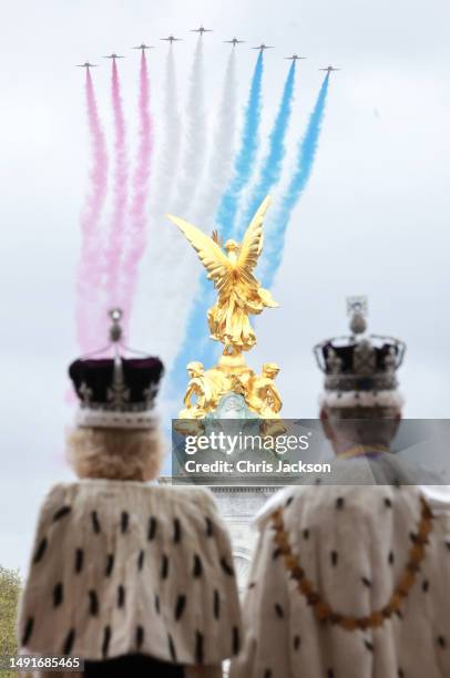 King Charles III and Queen Camilla watch the red arrows flypast from the balcony of Buckingham Palace after their Coronation on May 06, 2023 in...