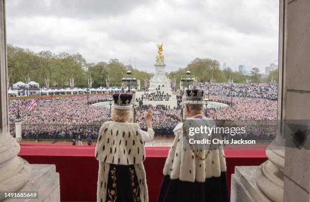 King Charles III and Queen Camilla wave from the balcony of Buckingham Palace after their Coronation on May 06, 2023 in London, England.