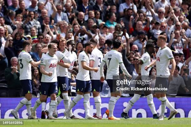 Harry Kane of Tottenham Hotspur celebrates with teammates after scoring the team's first goal during the Premier League match between Tottenham...