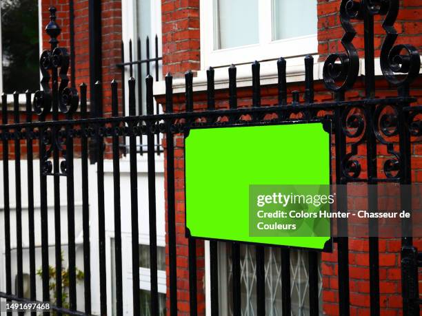 side view of an empty street name sign on the wrought iron railings of a residential building in london, england, united kingdom - commercial sign stock illustrations stock pictures, royalty-free photos & images