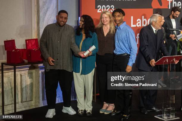 Participants of the Great Britain pavilion titled 'Dancing Before the Moon' pose for a portrait after receiving the special mention for National...