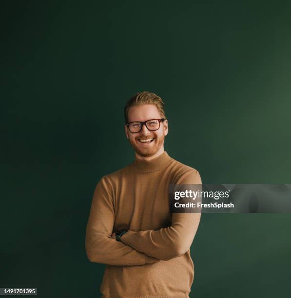 a happy handsome blond businessman with glasses looking at camera - blonde stockfoto's en -beelden