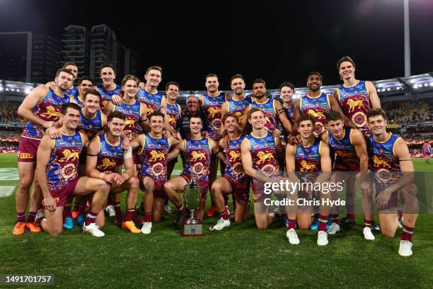 Lions celebrate winning the Q-Clash during the round 10 AFL match between Brisbane Lions and Gold Coast Suns at The Gabba, on May 20 in Brisbane,...