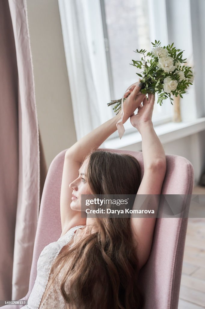 Beautiful Young Woman With Long Brown Hair In Wedding Dress And Flowers