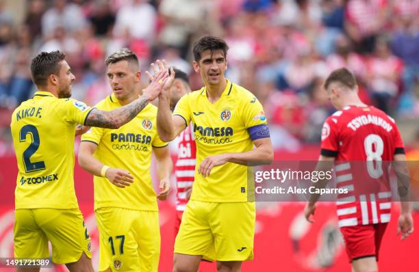 Gerard Moreno of Villarreal CF celebrates with teammates after scoring the team's second goal during the LaLiga Santander match between Girona FC and...