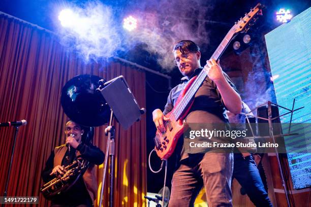 musician man playing electric bass while use digital tablet in a music concert - bass instrument stock pictures, royalty-free photos & images