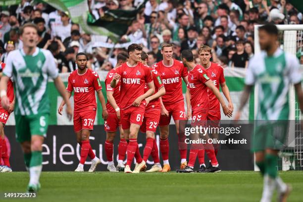 Steffen Tigges of 1.FC Koeln celebrates with teammates after scoring the team's first goal during the Bundesliga match between SV Werder Bremen and...