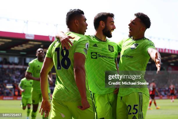 Casemiro of Manchester United celebrates with teammates Bruno Fernandes and Jadon Sancho after scoring the team's first goal during the Premier...