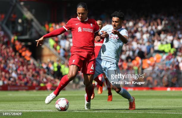 Virgil van Dijk of Liverpool and Ollie Watkins of Aston Villa battle for possession during the Premier League match between Liverpool FC and Aston...