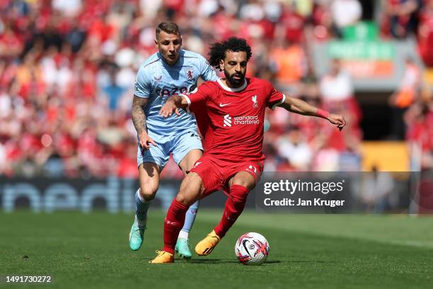 Mohamed Salah of Liverpool runs with the ball whilst under pressure from Lucas Digne of Aston Villa during the Premier League match between Liverpool...