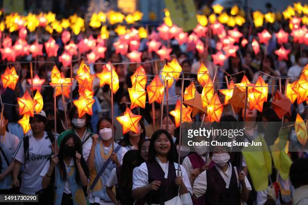 Buddhists carry lanterns in a parade during the Lotus Lantern Festival to celebrate the upcoming birthday of Buddha on May 20, 2023 in Seoul, South...