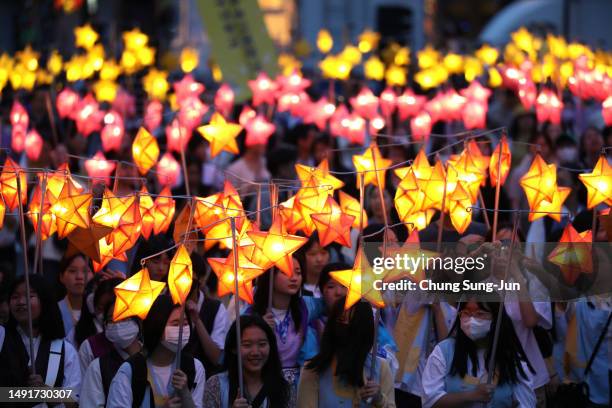 Buddhists carry lanterns in a parade during the Lotus Lantern Festival to celebrate the upcoming birthday of Buddha on May 20, 2023 in Seoul, South...