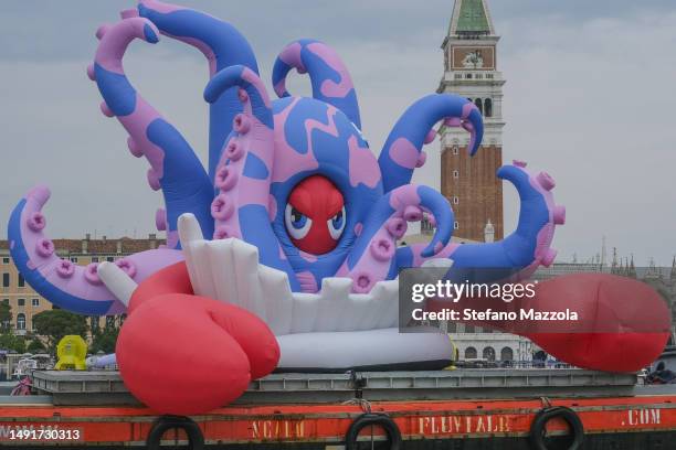 Boat carries a giant inflatable lobster titled: Lobster Octopus from Pompeii created by British artist Philip Colbert in Venice's San Marco Basin...