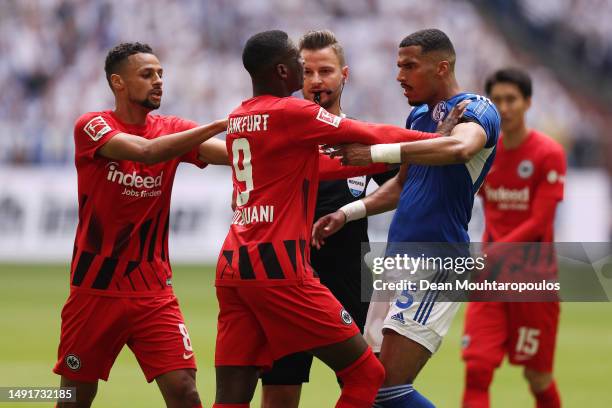 Randal Kolo Muani of Eintracht Frankfurt clashes with Moritz Jenz of FC Schalke 04 during the Bundesliga match between FC Schalke 04 and Eintracht...