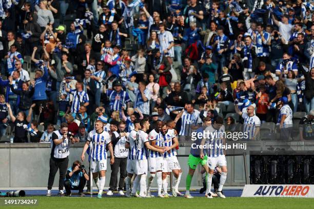 Lucas Tousart of Hertha Berlin celebrates with teammates after scoring the team's first goal during the Bundesliga match between Hertha BSC and VfL...
