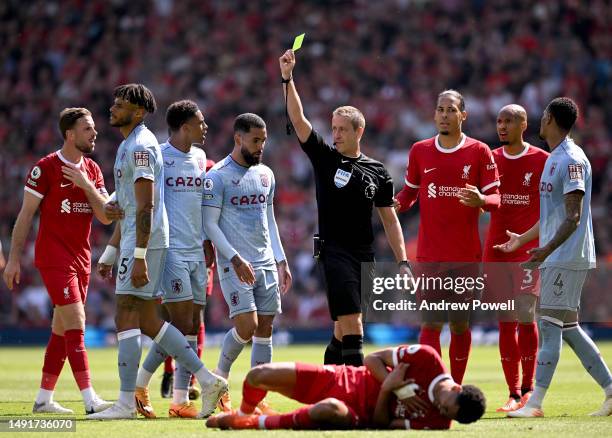 Tyrone Mings of Aston Villa getting a yellow card during the Premier League match between Liverpool FC and Aston Villa at Anfield on May 20, 2023 in...